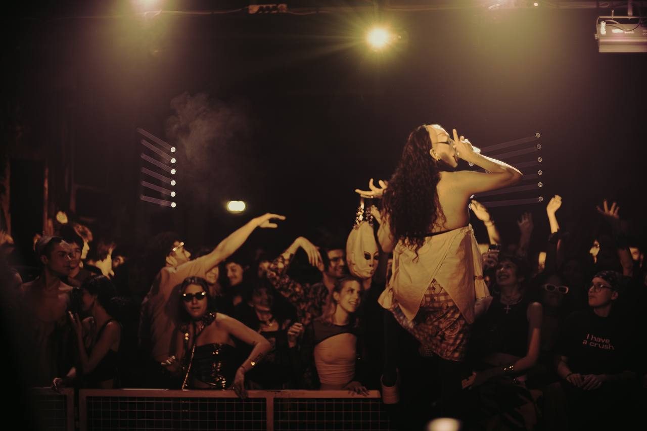 wiqi performing on stage, raised above the crowd