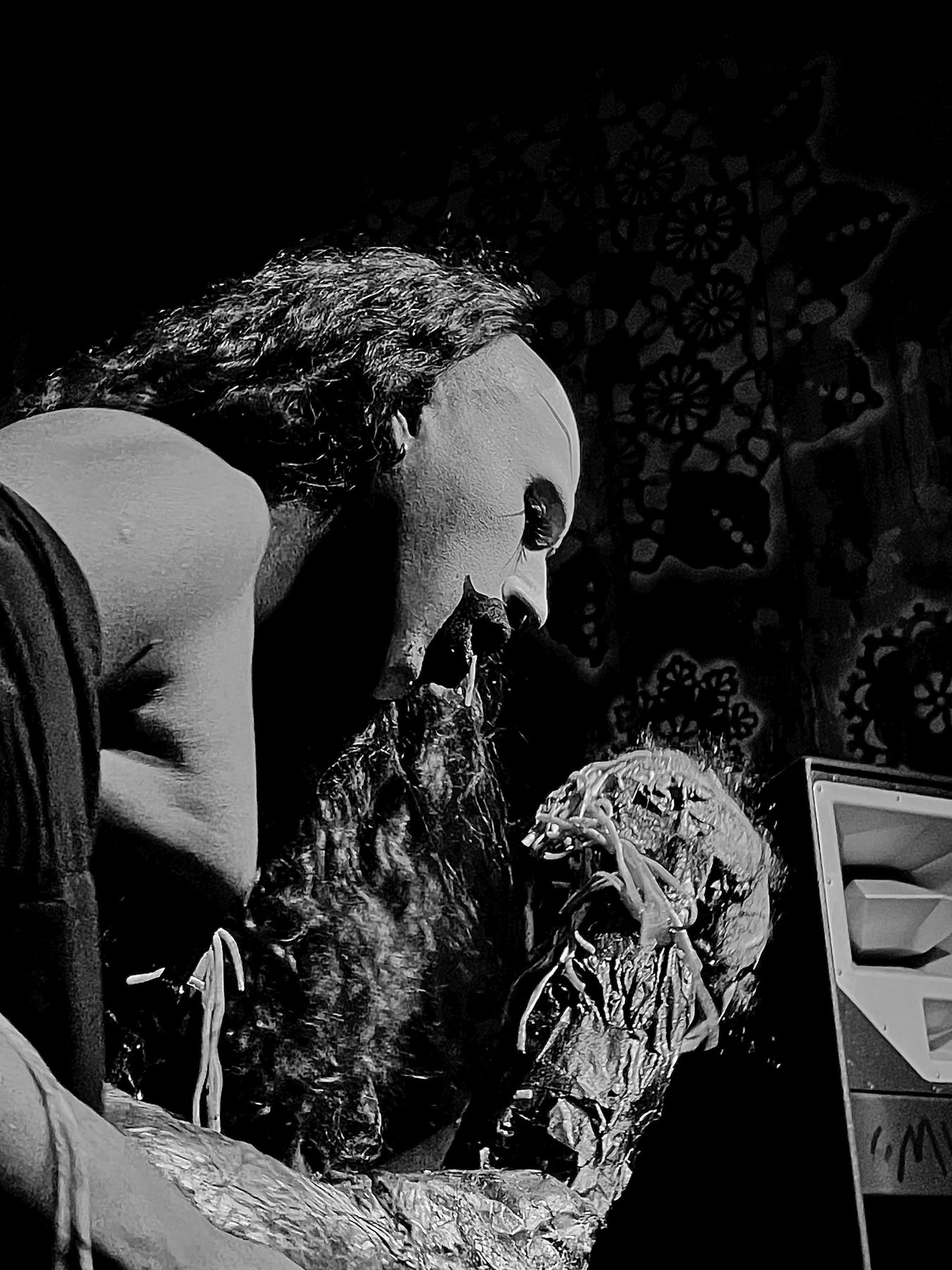 wiqi in profile wearing a pale mask, black and white